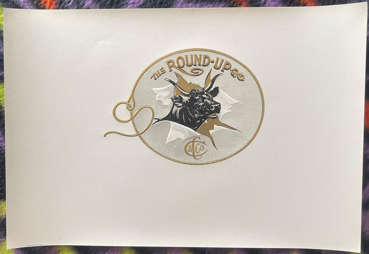 Embossed cigar label featuring a bull's head in a rope circle with "The Round-Up" text and decorative rope border on cream pa