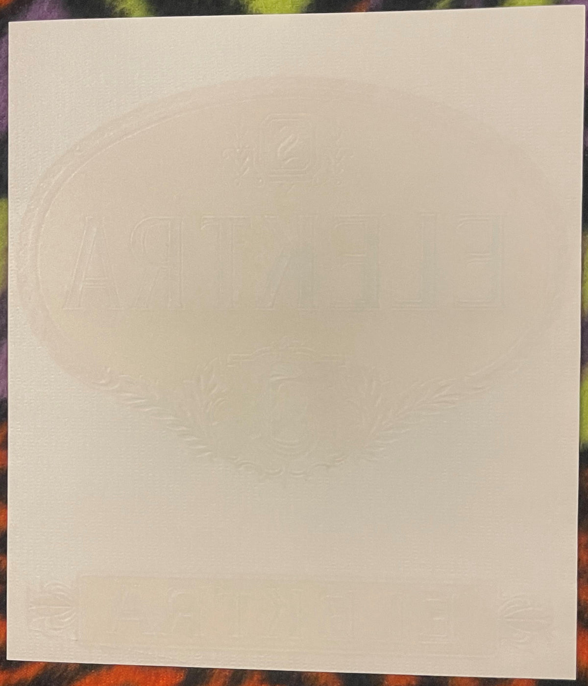 Back of the Elektra cigar label: blank textured paper with the oval and lettering embossed through from the front