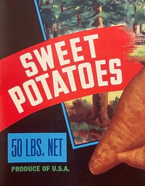 Vintage sweet potato crate label with red banner and blue text, held by a hand for scale, showing "50 LBS. NET" and "PRODUCE 