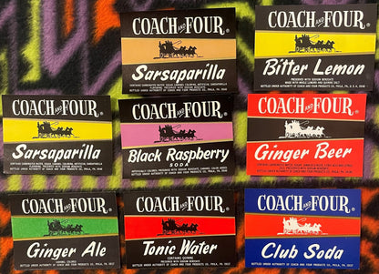 Nine vintage Coach and Four soda bottle labels from the 1960s arranged on a colorful striped fabric background, featuring fla