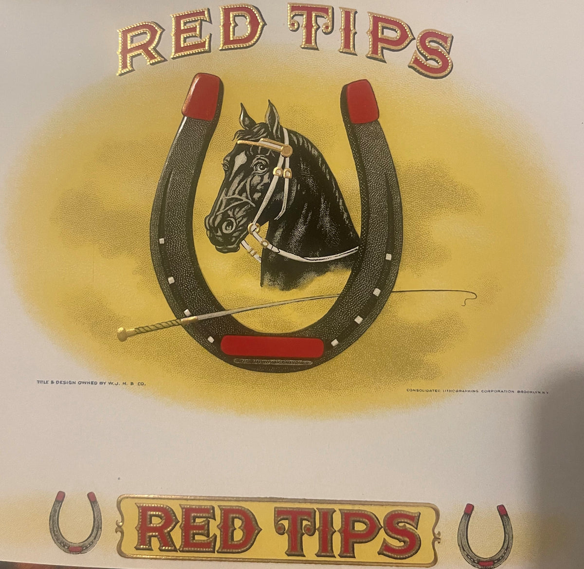 Red Tips cigar label: a black horse's head in a white bridle framed by a horseshoe with red-tipped heels and a riding crop, RED TIPS in red and gold above