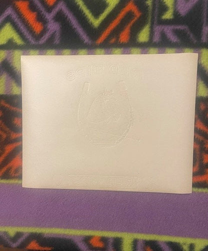 Back of the Red Tips cigar label: plain paper with the horseshoe, the horse's head and the RED TIPS lettering embossed through in reverse