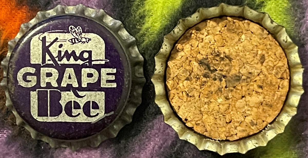 Two views of an antique King Bee Grape Soda bottle cap: purple crown cap with bee logo and white text on left; cork-lined interior with tan cork visible on right.