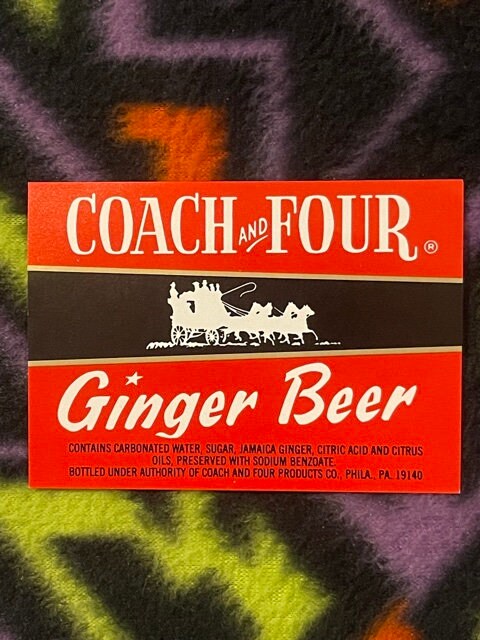 Vintage Coach and Four Ginger Beer label with red and black design, white text, horse-drawn coach silhouette, Philadelphia