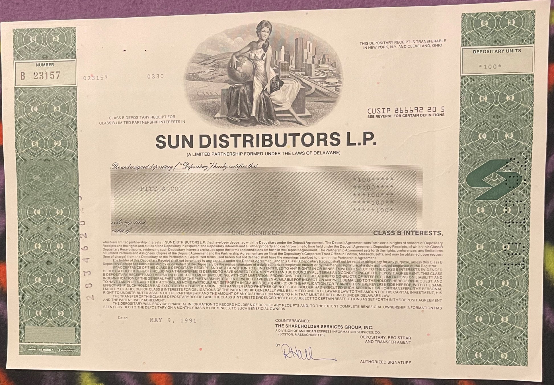 Sun Distributors L.P. Class B stock certificate with green decorative borders, allegorical female figure holding globe