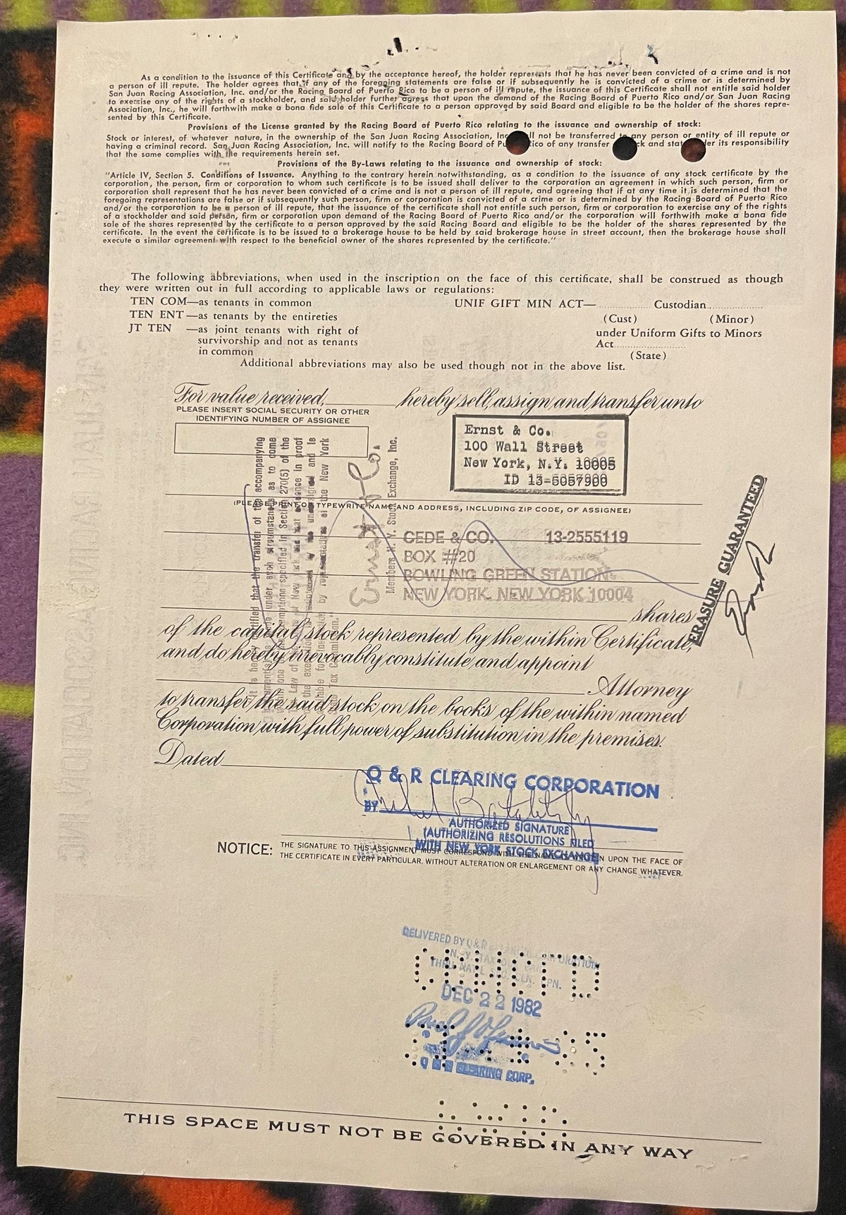 Vintage stock certificate from San Juan Racing Association with typed assignee details, handwritten signatures, and blue rubb