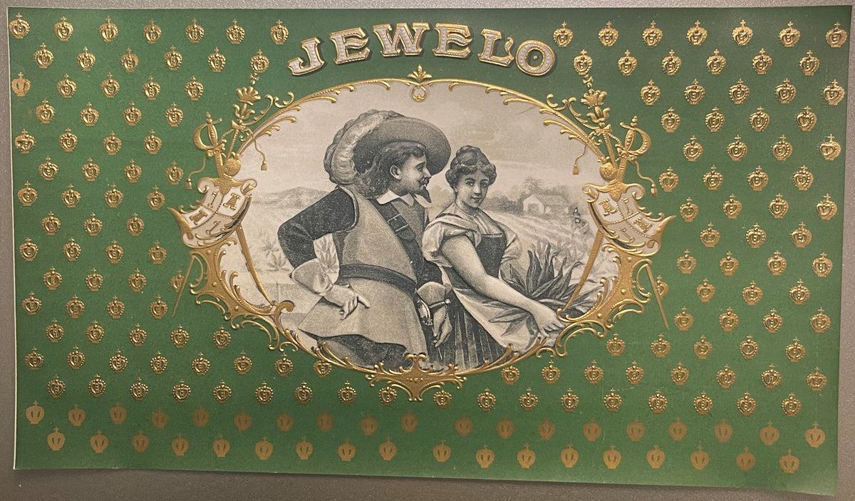 Antique "Jewelo" cigar label with gold-embossed text on green background, featuring two figures in period costume within orna