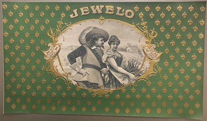 Antique "Jewelo" cigar label with gold-embossed text on green background, featuring two figures in period costume within orna