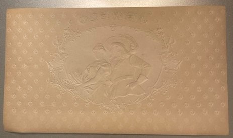 Tan embossed cigar label featuring a swashbuckler figure in relief against a dotted background pattern