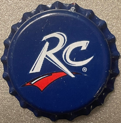 Navy blue bottle cap with white "RC" logo and red swoosh, shown flat against textured gray surface