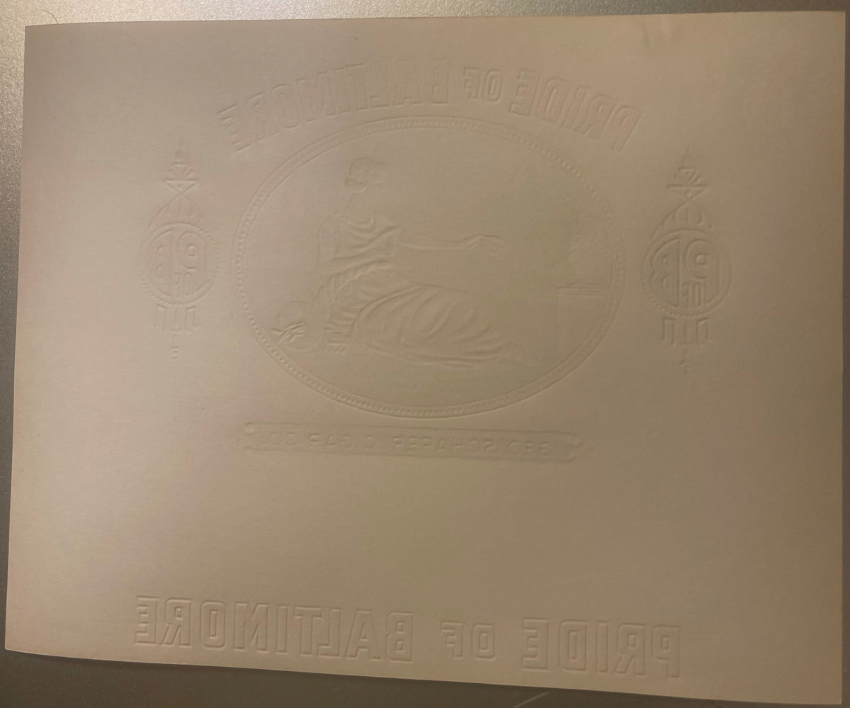 Embossed cream-colored cigar label with ornate oval centerpiece, decorative corner designs, and text reading "Pride of Baltim