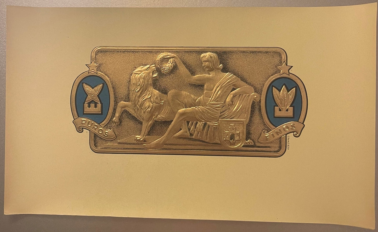 Gold embossed cigar label on cream cardstock featuring classical figures, lion, and blue shield emblems marked "Puros" and "F