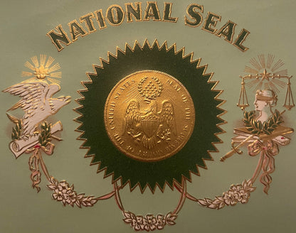 Embossed cigar label with "National Seal" text, central gold coin on dark rosette, flanked by winged eagle and Lady Justice s