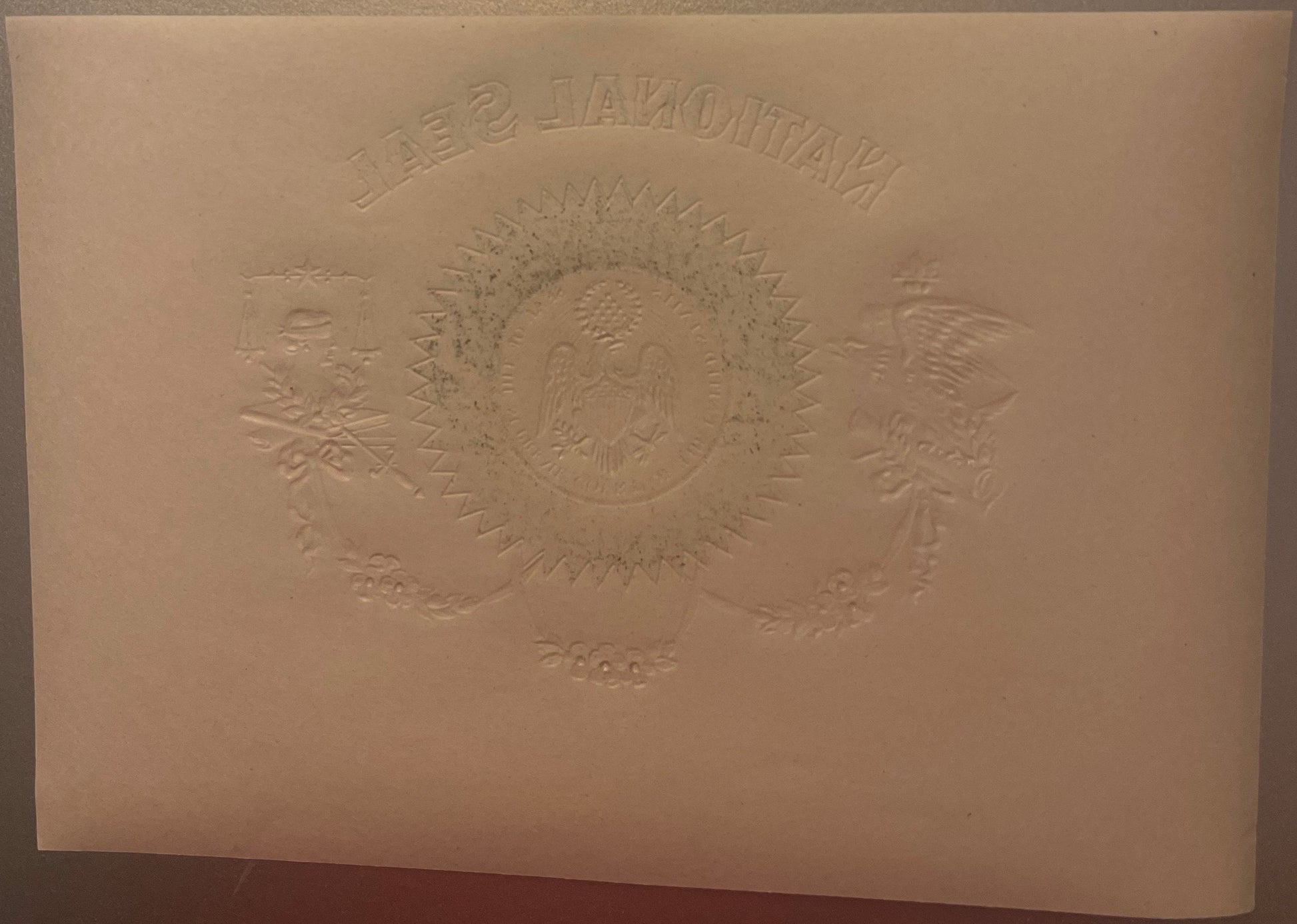 Cream-colored embossed cigar label featuring two eagles flanking a central shield with "NATIONAL SEAL" text at top, shown at 