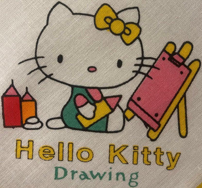 Vintage Hello Kitty cotton napkin with yellow bow, sitting in chair holding pink item, printed text and colorful design on cr