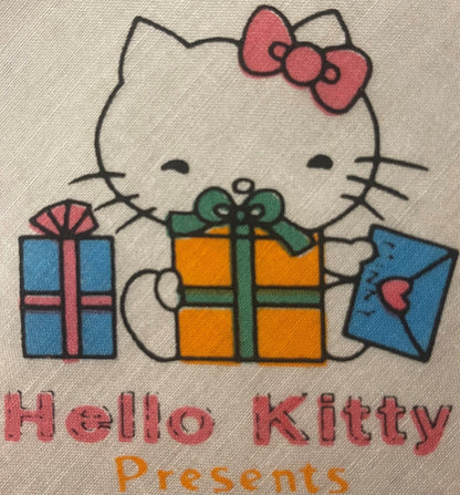 Vintage Hello Kitty cotton napkin with character surrounded by colorful gift boxes, pink bow, and "Hello Kitty Presents" text