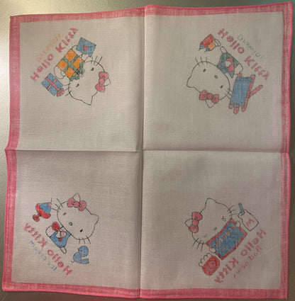 Unfolded pink-bordered cotton napkin with four Hello Kitty illustrations in different poses holding gifts and presents, print