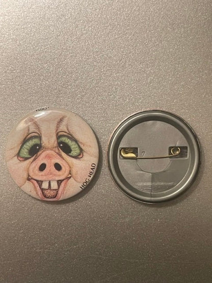 Hog Head pig face button shown beside a grey plastic button back with a brass safety pin