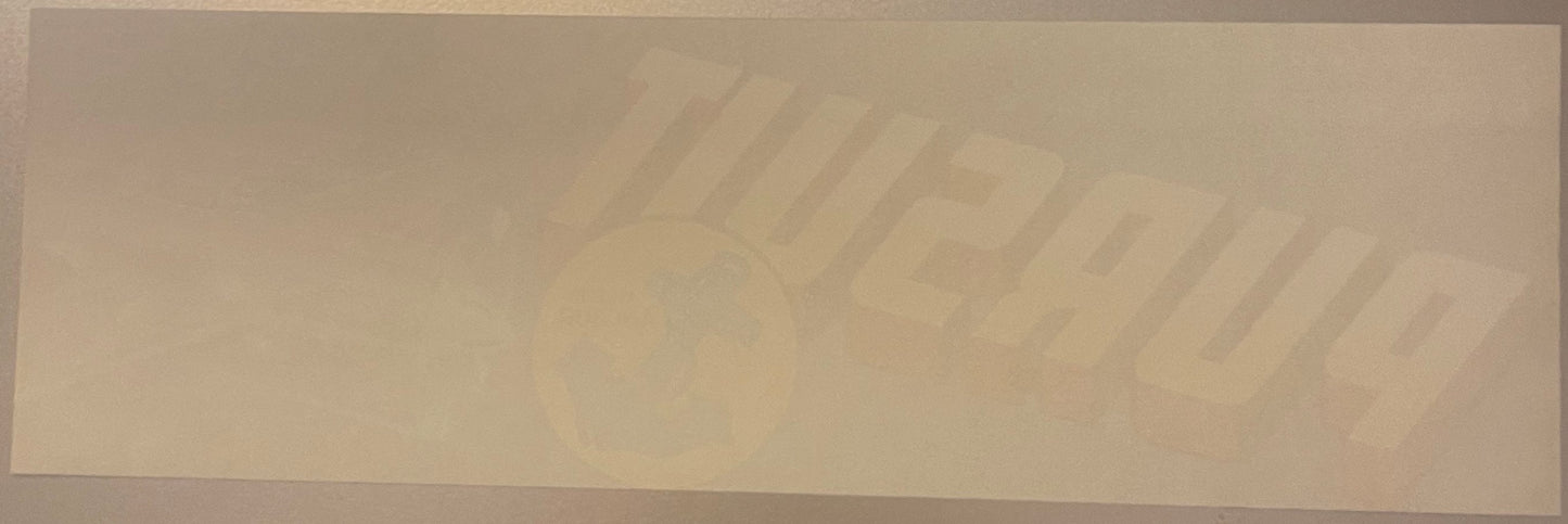 Faded vintage crate label with embossed or debossed text reading "Pursuit" and partial imagery, cream-colored paper on neutra