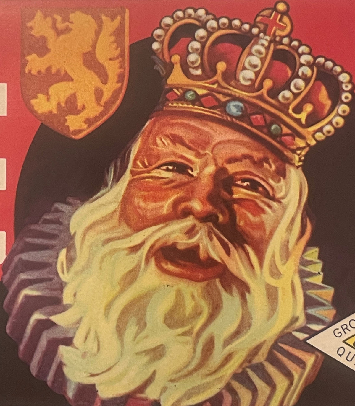 Vintage fruit crate label featuring a bearded king wearing an ornate crown, with a lion shield emblem above, on red