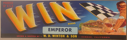 Vintage fruit crate label with orange "WIN" letters, "EMPEROR" brand text, checkered flag, and illustration of man