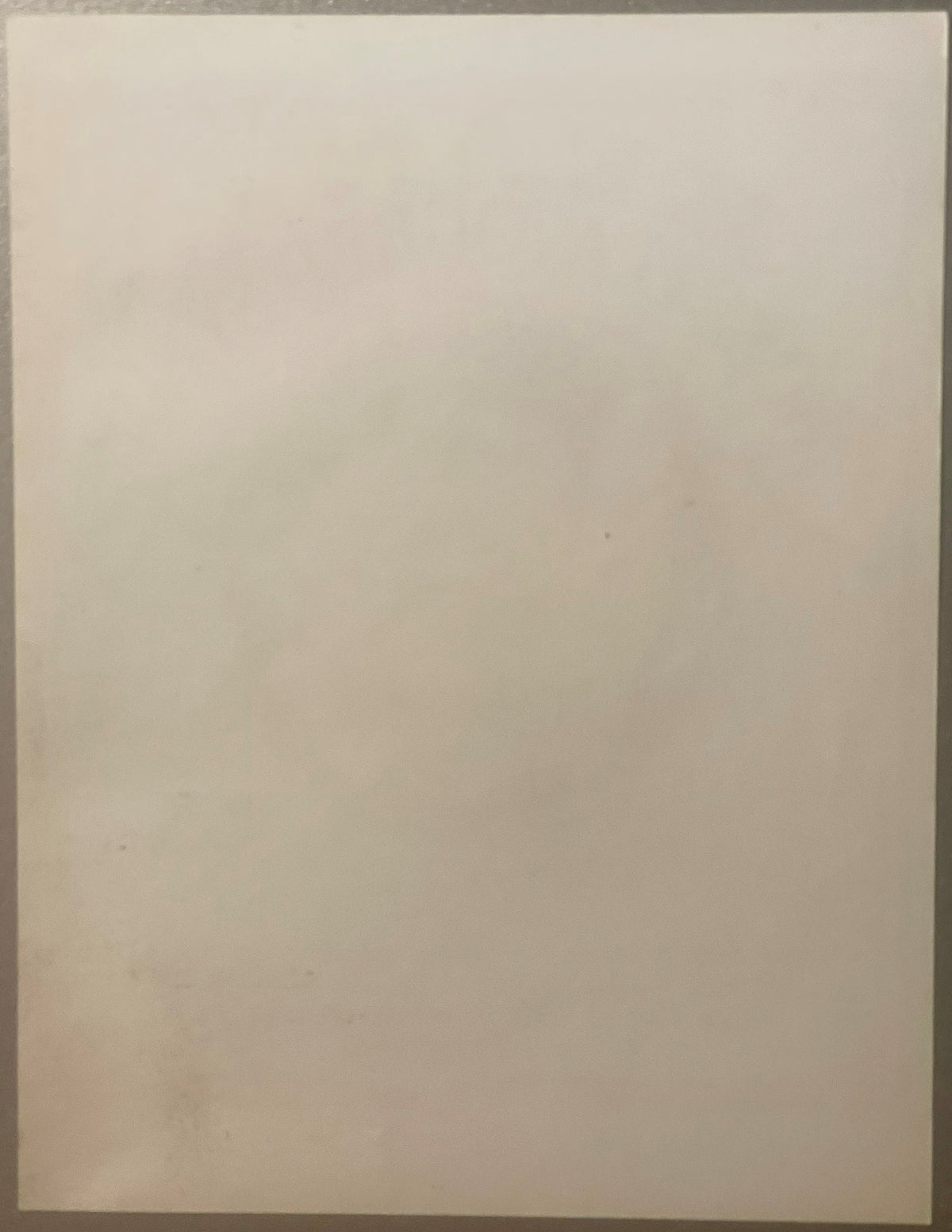 Blank cream-colored page or back of vintage syrup label against neutral background