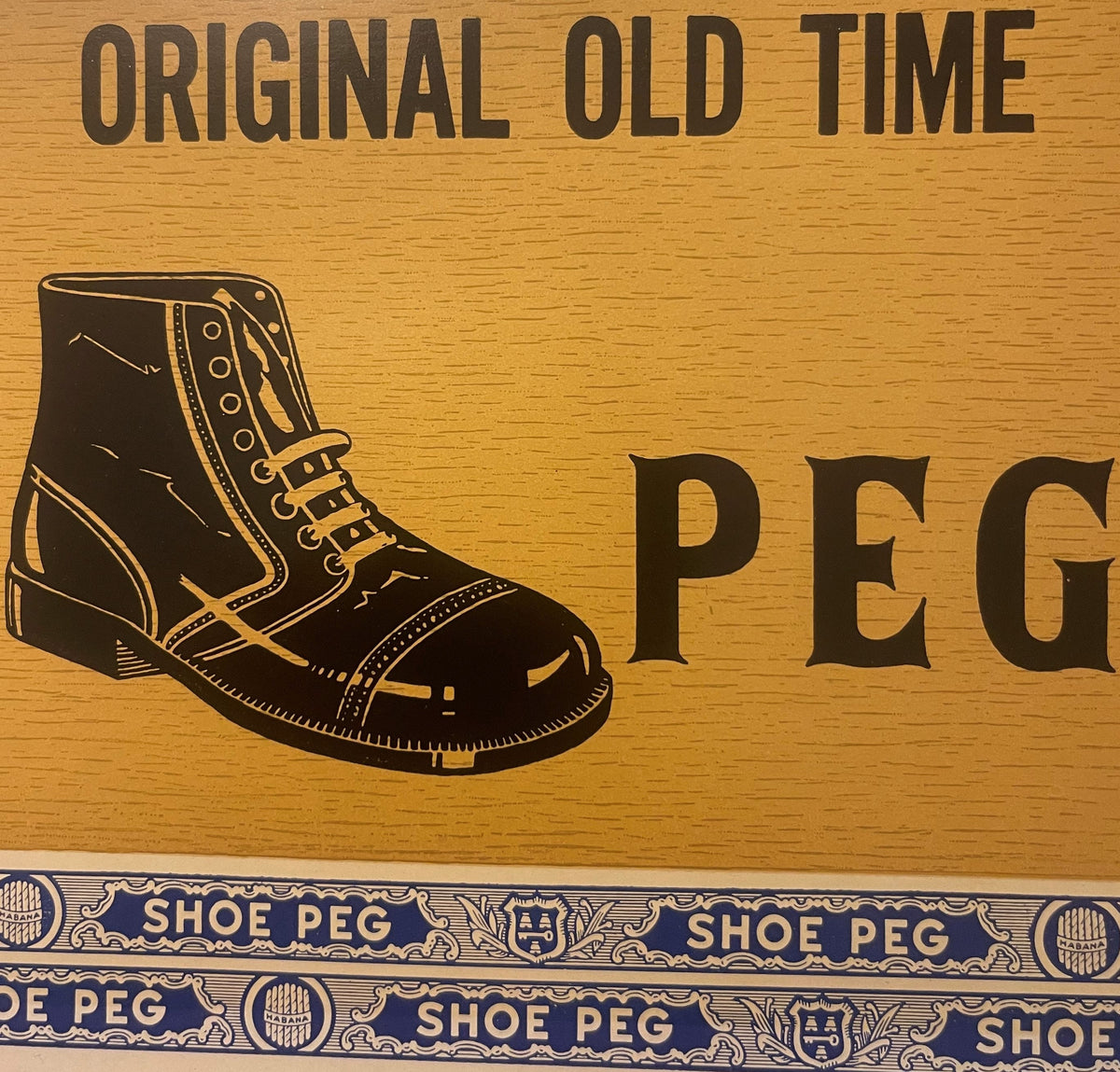 Antique lithograph cigar box label on wood showing laced boot illustration, "Original Old Time Peg" text, and decorative