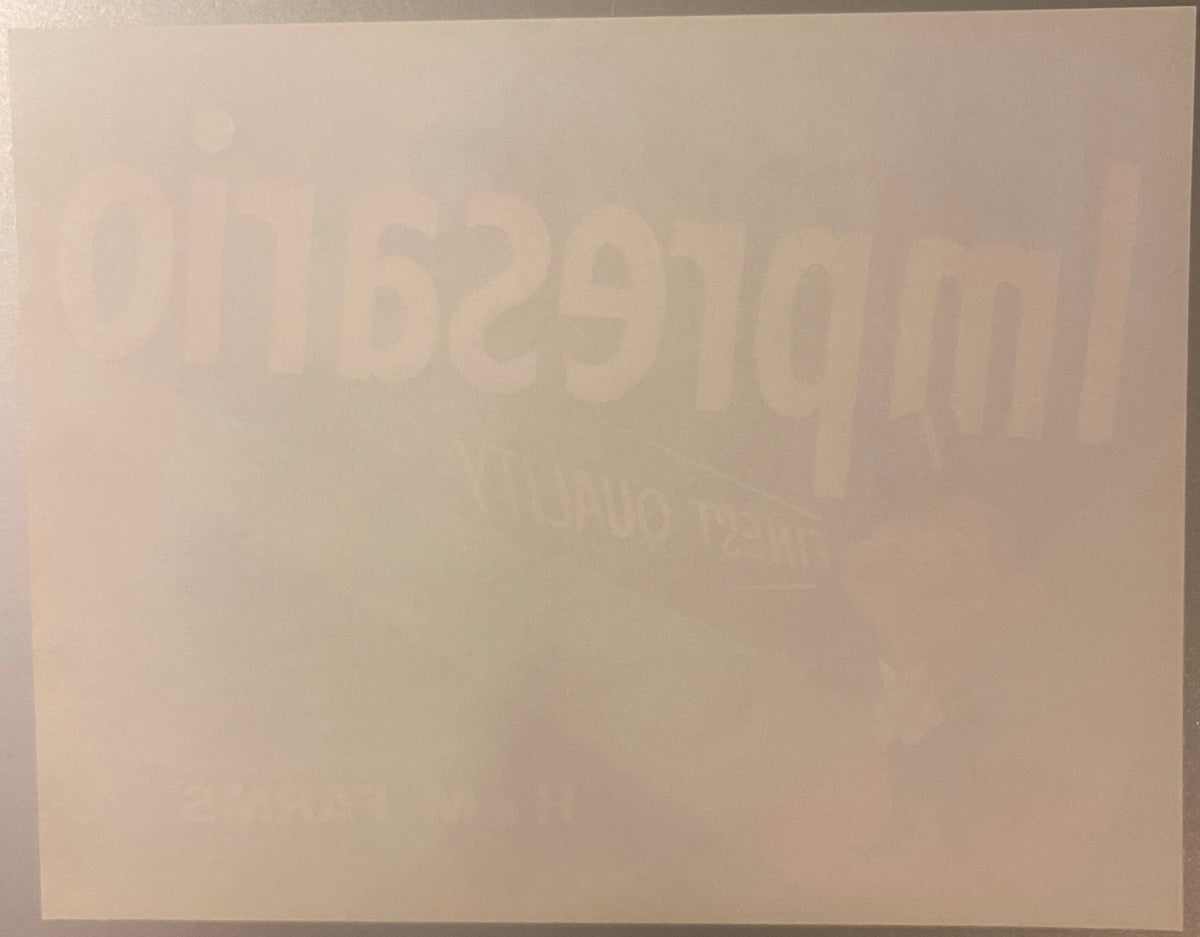 Vintage crate label with embossed text reading "Impresario" and partial text visible, cream and tan coloring