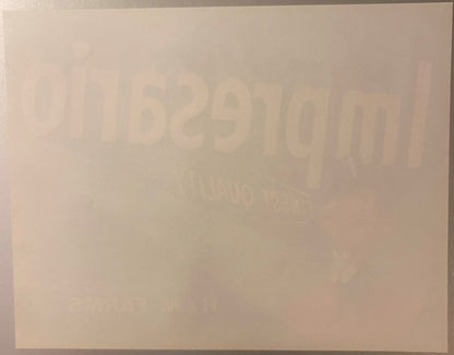 Vintage crate label with embossed text reading "Impresario" and partial text visible, cream and tan coloring