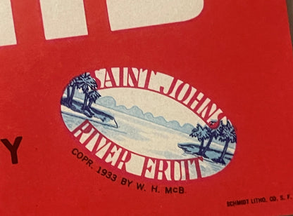 Vintage red citrus crate label with cream oval center showing pastoral landscape, text reading "Saint John River Fruit" and c