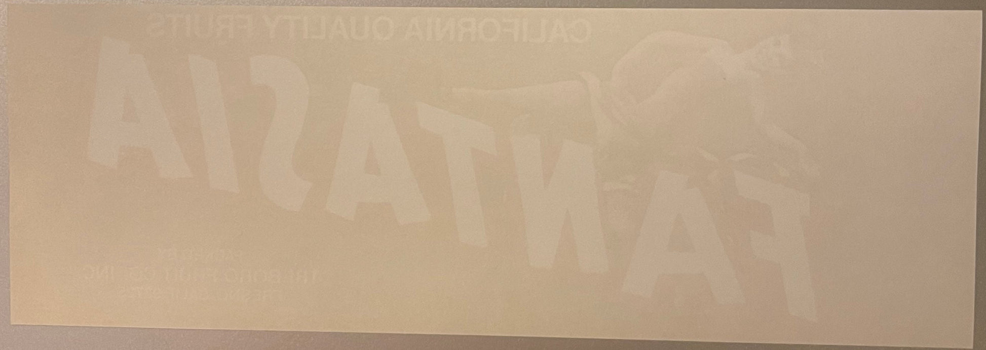 Faded vintage Fantasia fruit crate label with tan and cream colors, text barely visible against light background