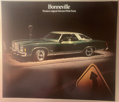 1974 Pontiac Bonneville dealer brochure cover showing dark green full-sized car photographed at night under spotlight, with "Bonneville" and "Pontiac's original full-sized Wide-Track" text at top, Pontiac logo visible on hood.