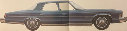 Side profile illustration of a 1974 Pontiac Bonneville 4-door sedan in Admiralty Blue with white-wall tires, shown against a beige background with model name and color printed below.