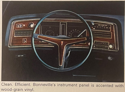 1974 Pontiac Bonneville dashboard interior view featuring steering wheel, wood-grain vinyl instrument panel, and gauges. Text reads