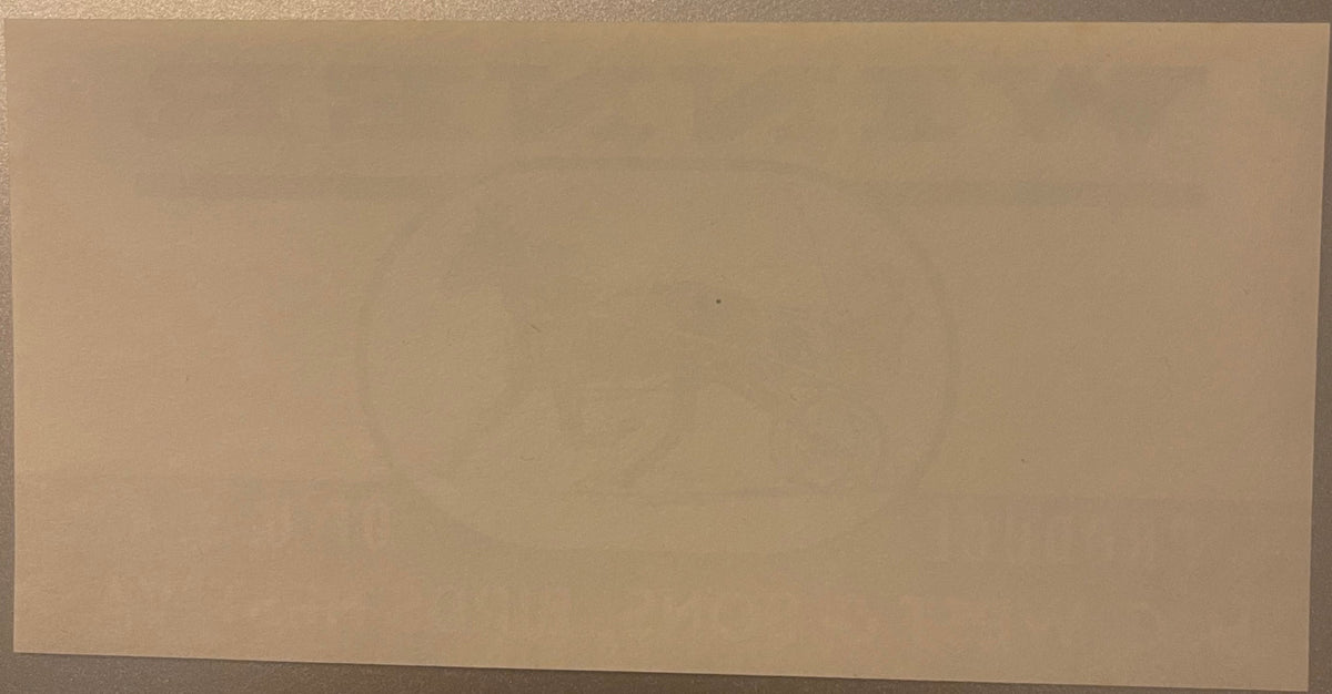 Blank cream-colored antique crate label with minimal visible text or imagery, shown at slight angle against neutral