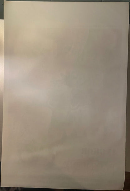 Blank cream-colored paper or poster backing shown at an angle against a gray wall