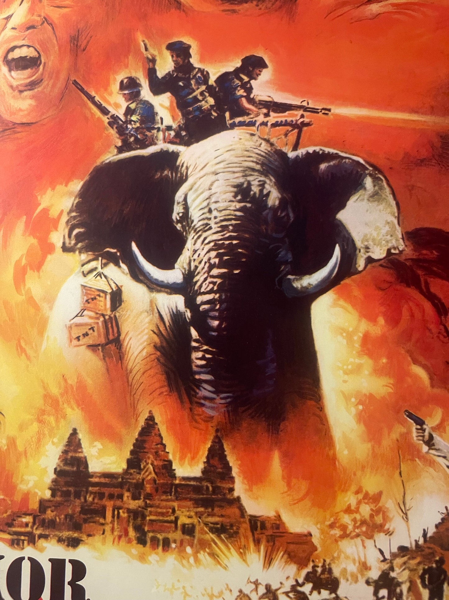 Vintage movie poster featuring a large elephant with armed soldiers on its back, temples and flames in background, orange and