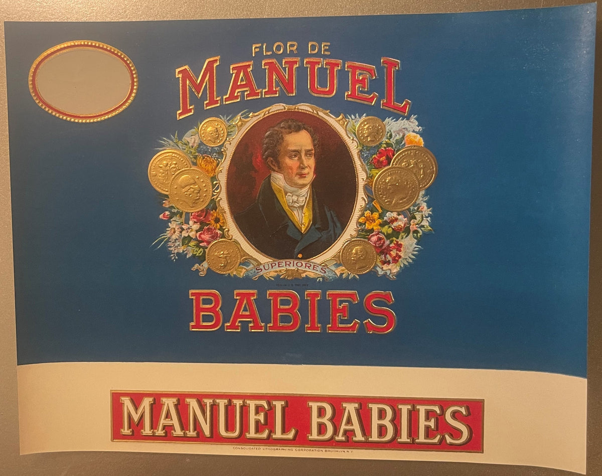 Vintage cigar label with blue background featuring portrait of man in oval frame surrounded by gold coins and flowers, text r