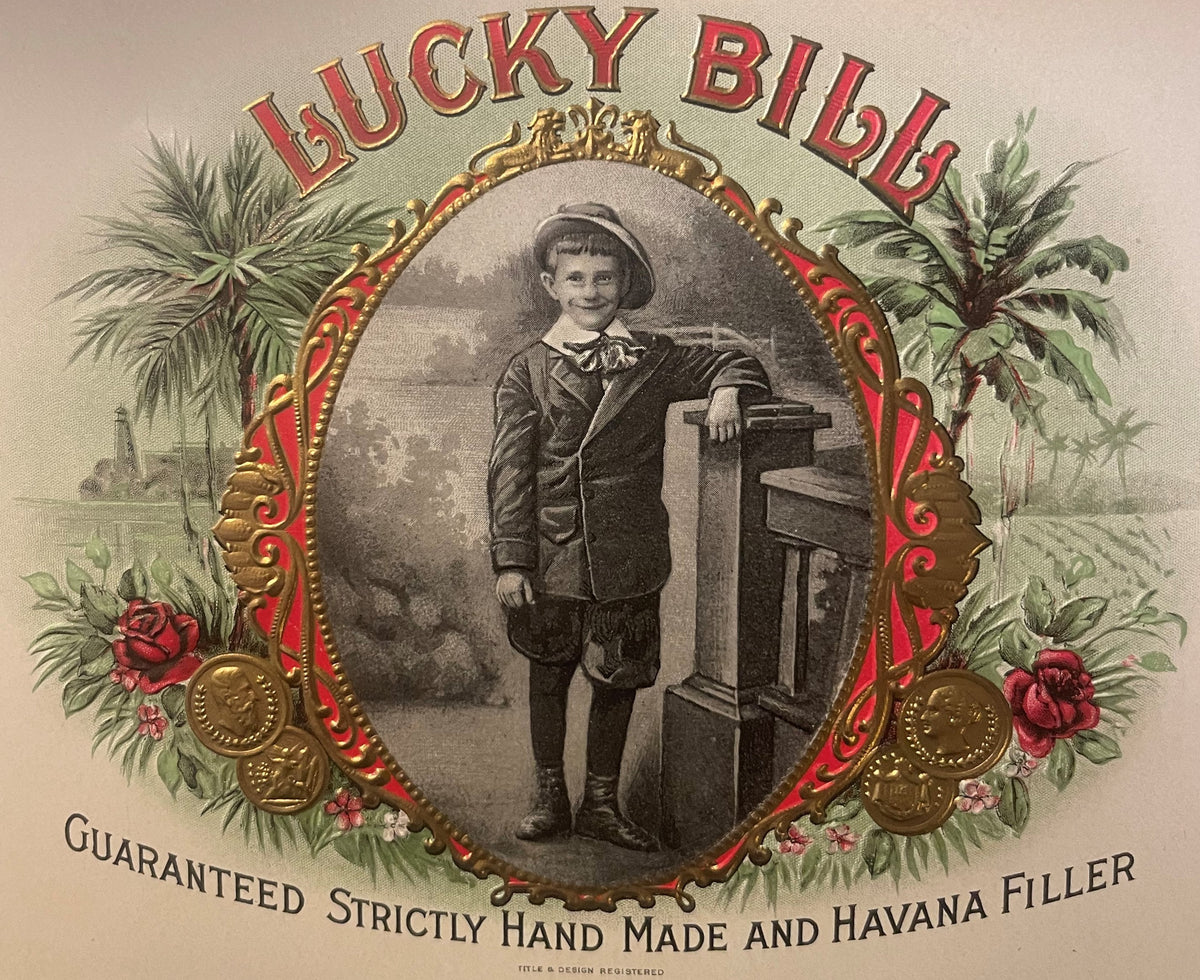 Ornate gold-embossed cigar label featuring "Lucky Bill" text, Victorian boy in formal attire with hat leaning on desk, surrou