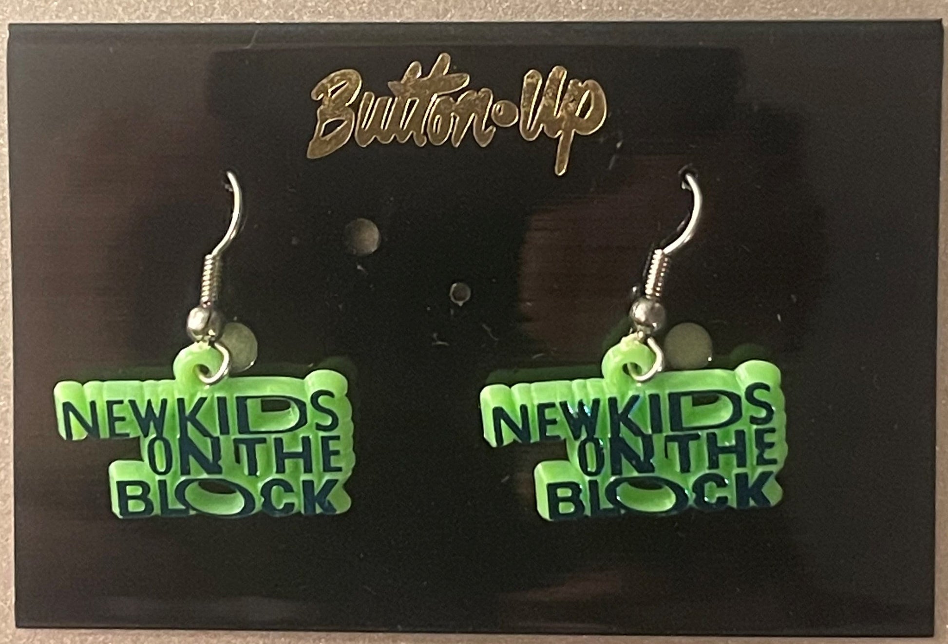 Pair of green "New Kids on the Block" dangle earrings on black card with gold "Bling'd Up" header and silver ear wires