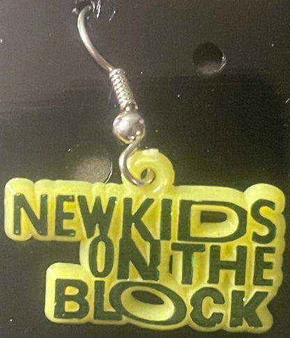 Yellow plastic charm earring with silver hook displayed against dark background, text reads "NEW KIDS ON THE BLOCK