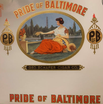 Vintage cigar label with gold foil embossing showing classical woman in red drape by waterfront, "Pride of Baltimore" text, G