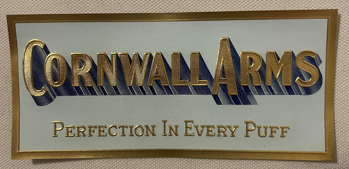 Antique Cornwall Arms small cigar label: CORNWALL ARMS in raised gold capitals with a blue shadow and PERFECTION IN EVERY PUFF, inside a gold rule on pale blue-gray.