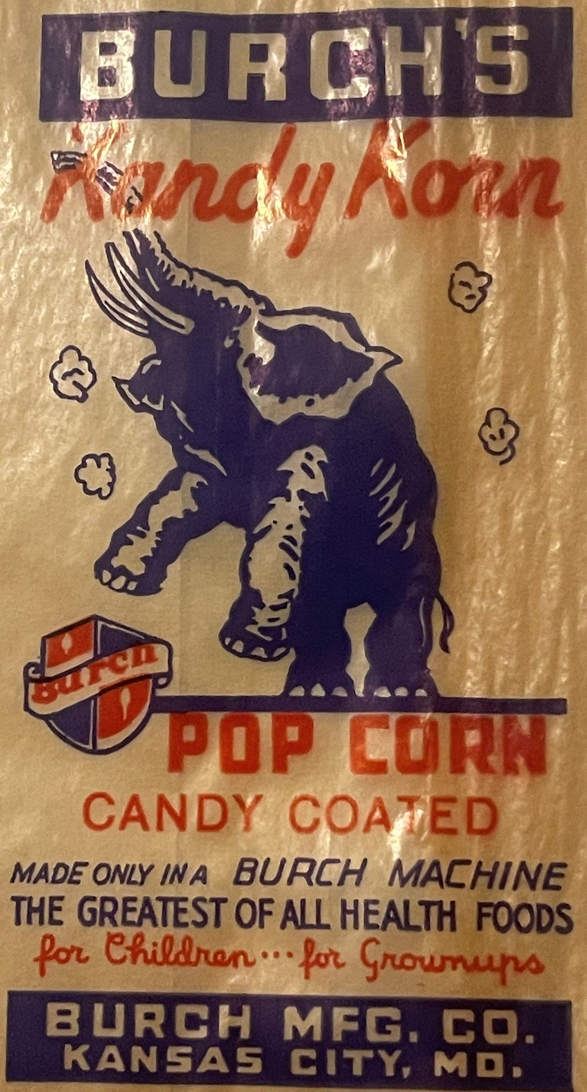 Vintage popcorn bag with purple bull illustration, red and black text reading "Burch's Kandy Korn" and manufacturer details f