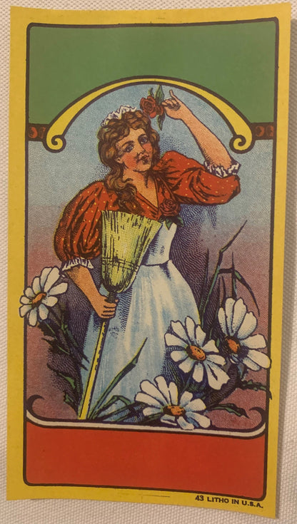 Vintage lithograph broom label featuring Art Nouveau woman in red blouse holding wheat bundle surrounded by white daisies