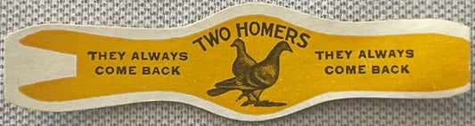 Vintage yellow cigar band with scalloped edges featuring illustration of homing pigeon and text "Two Homers They Always Come 
