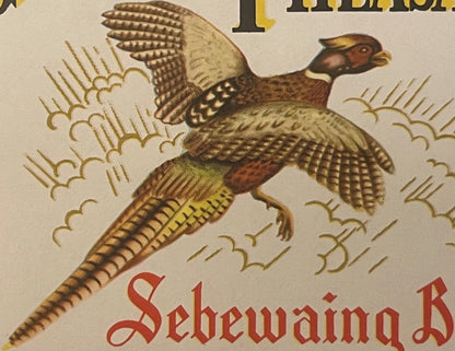 Colorful vintage beer label featuring a brown pheasant with spread wings in flight, ornate decorative elements, and red Gothi