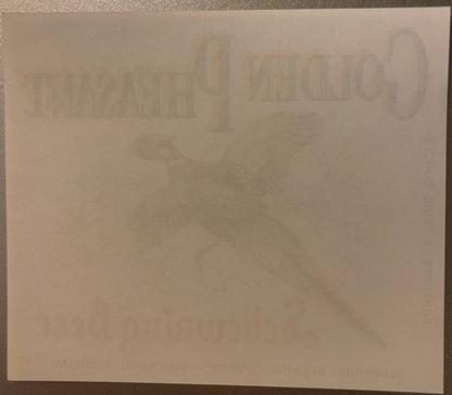 Faded vintage beer label with embossed Golden Pheasant branding and Michigan brewery text, displayed on cream paper against d