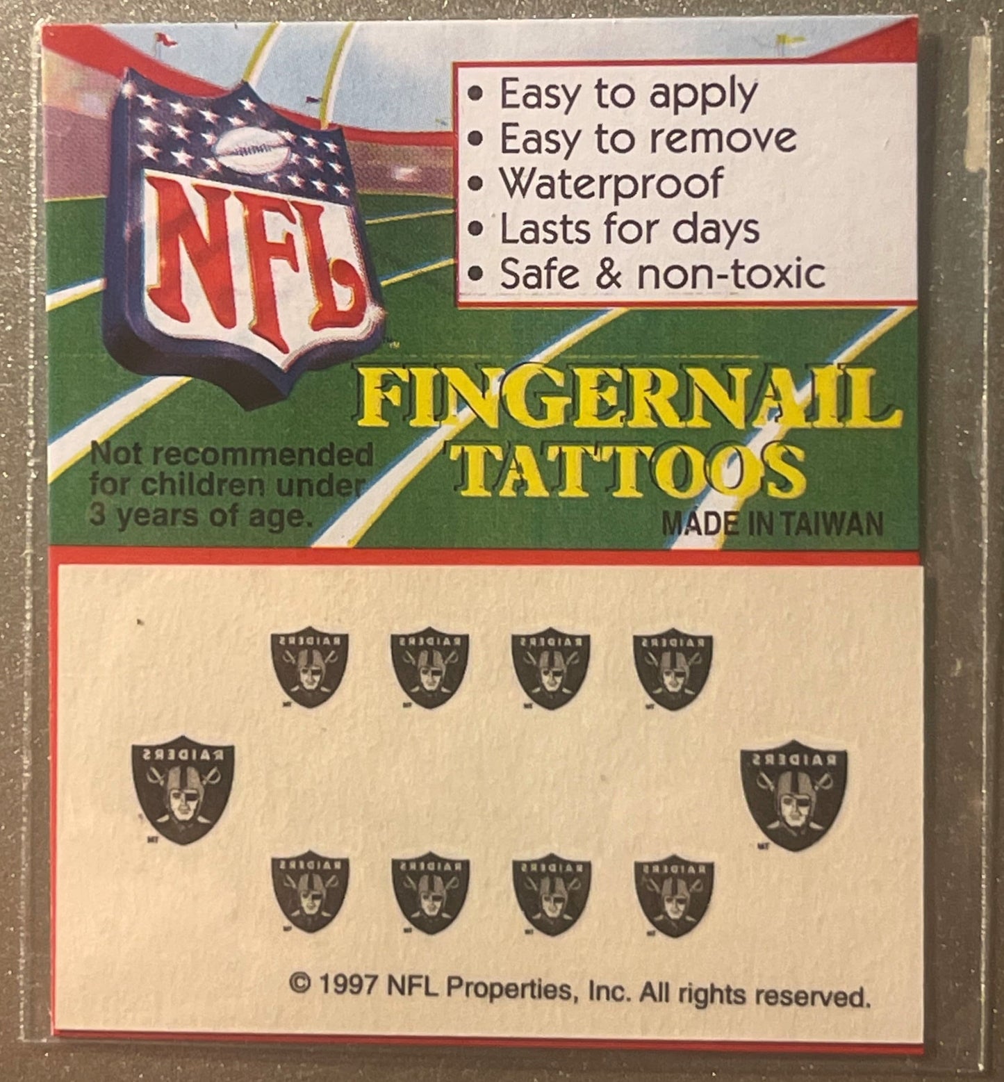 Sealed package of 1997 NFL Oakland Raiders fingernail tattoos showing product card with team logo, feature list, and sheet of