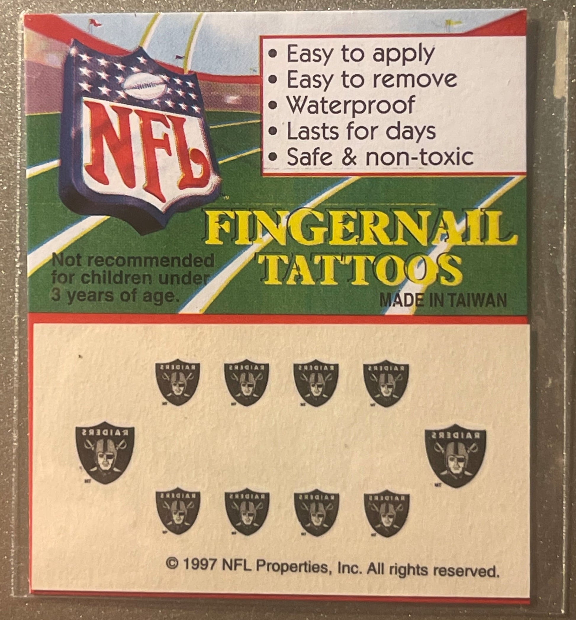 Sealed package of 1997 NFL Oakland Raiders fingernail tattoos showing product card with team logo, feature list, and sheet of